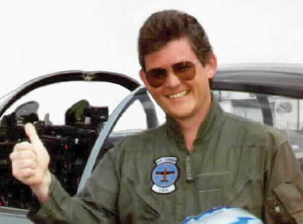 Joe Dever in front of his plane giving the "thumb"s up"